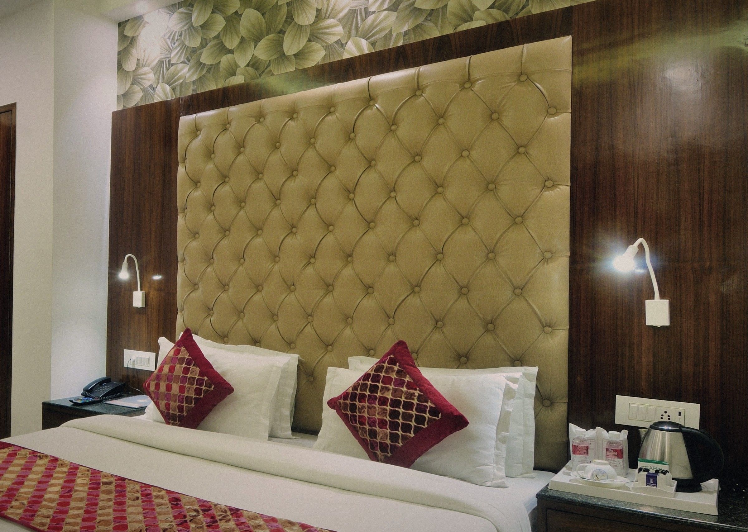 Tufted headboard and silk cushions in a Super Deluxe room