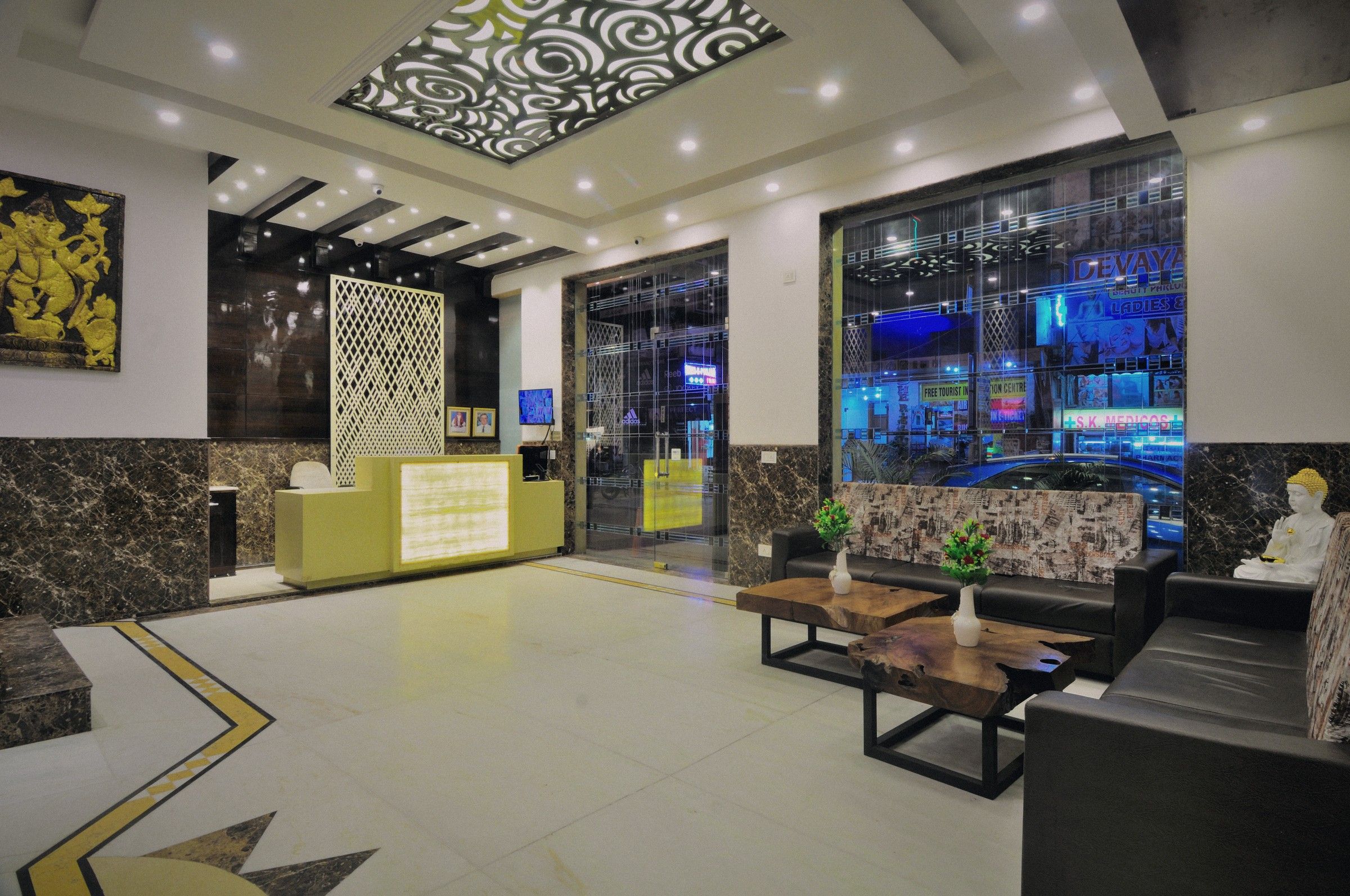 The Yuvraj lobby at night, the street lit up beyond the glass