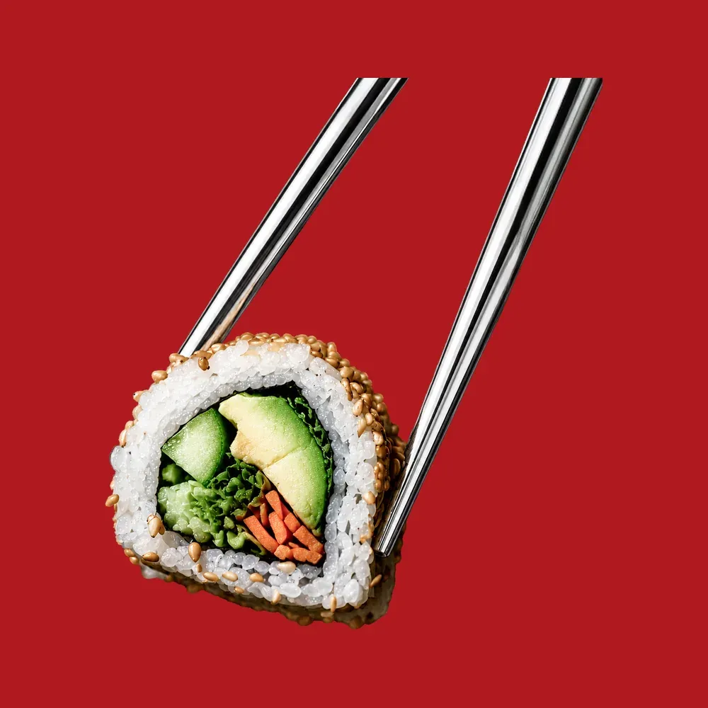 Uramaki roll held in chopsticks